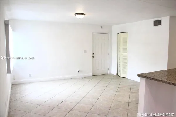 a kitchen with a stove top oven and cabinets