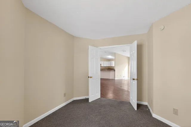 a view of an empty room and closet