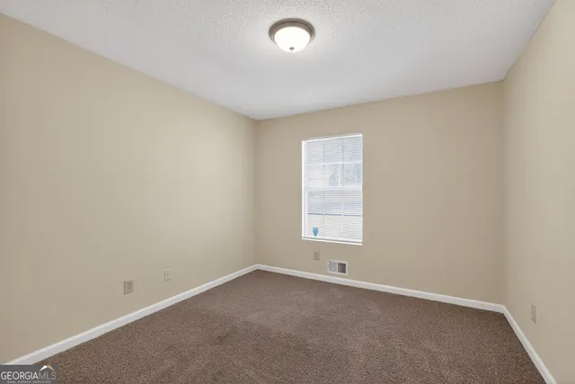 an empty room with a empty space and a window