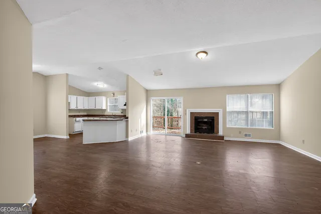 a view of kitchen with stove and cabinets