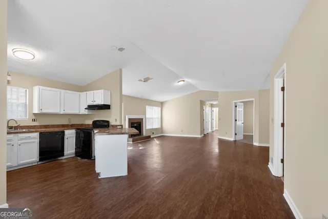 a view of a kitchen with a sink and a stove top oven