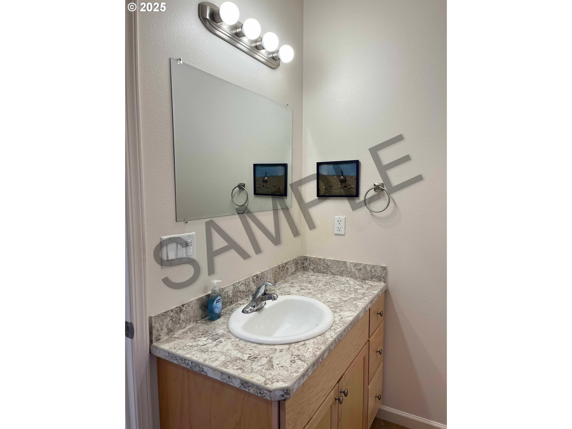 1577 37th Street Florence, OR 97439 - Photo 28 of 48 a bathroom with a granite countertop sink and a mirror