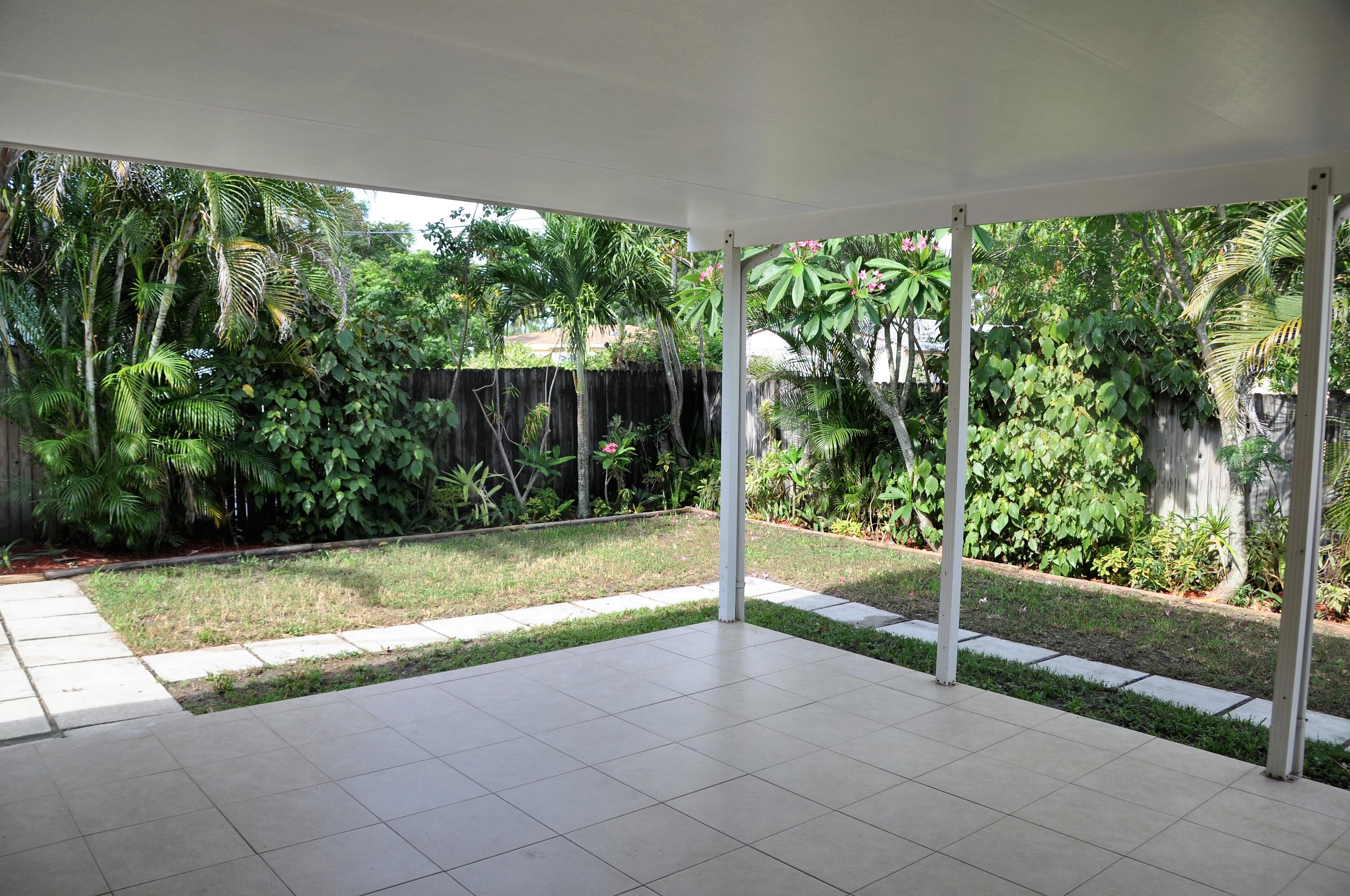 3025 Robert Road West Palm Beach, FL 33405 - Photo 15 of 41 a view of backyard with large trees and plants
