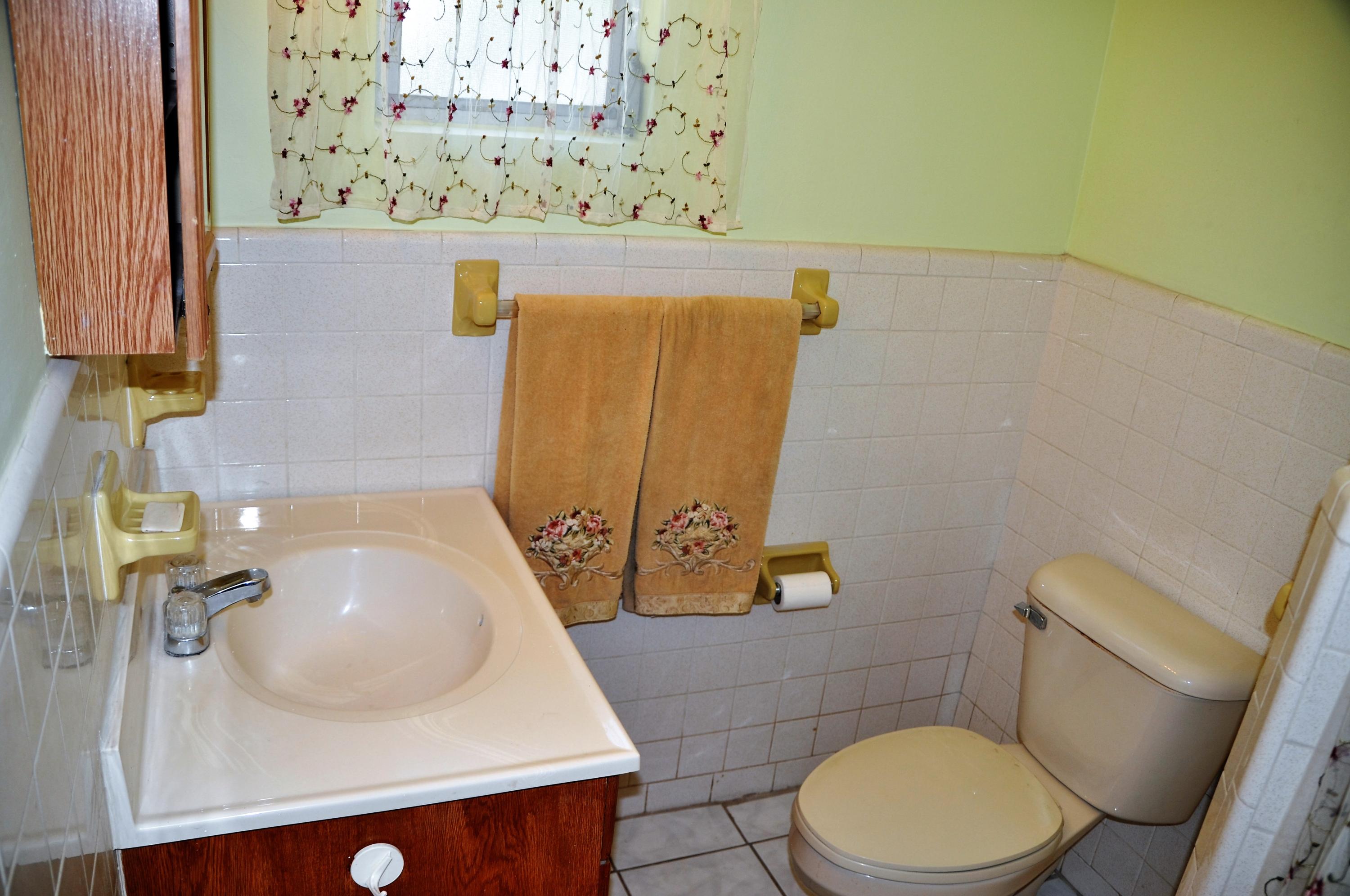 3025 Robert Road West Palm Beach, FL 33405 - Photo 24 of 41 a bathroom with a sink and a mirror