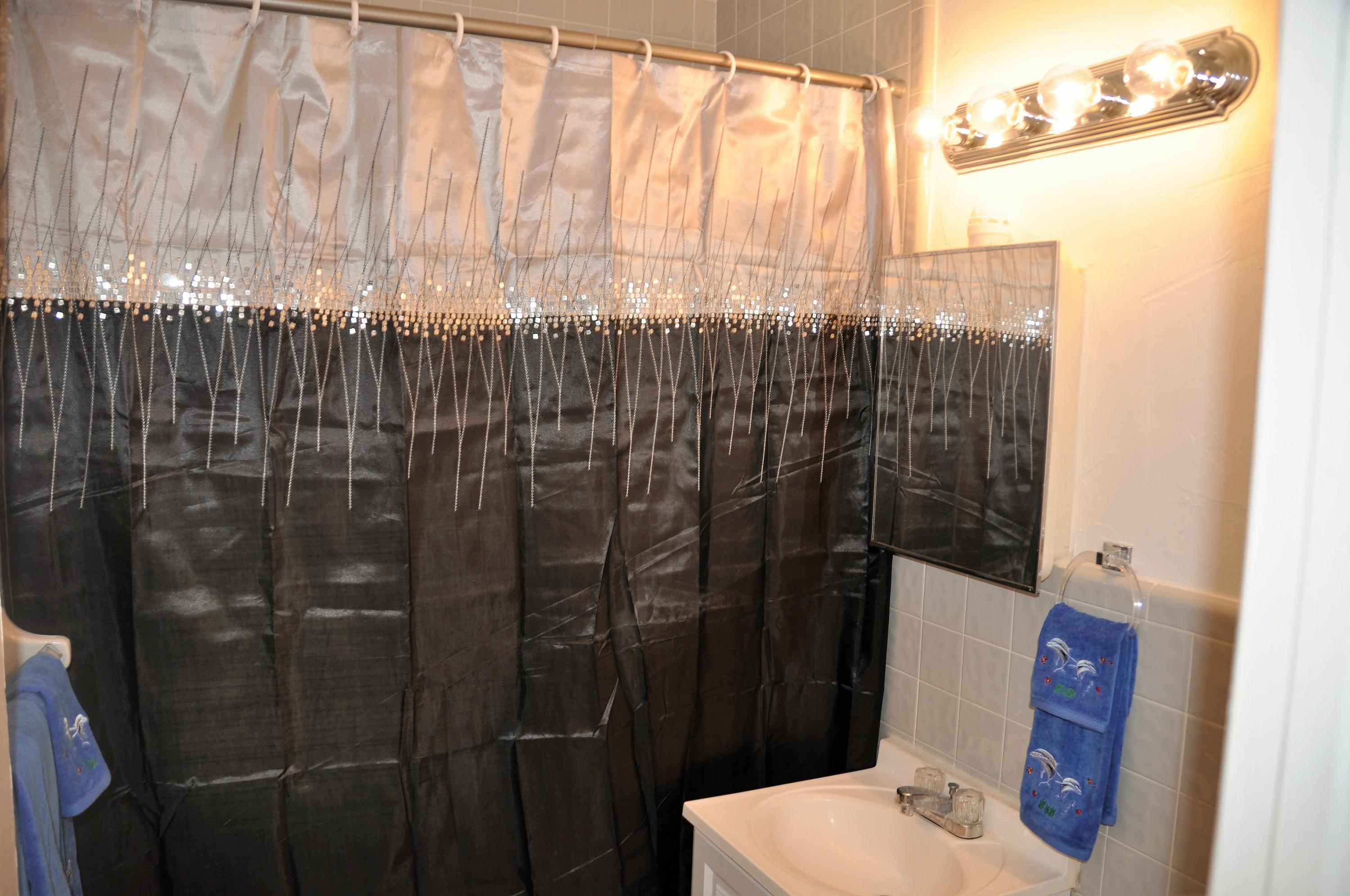 3025 Robert Road West Palm Beach, FL 33405 - Photo 37 of 41 a bathroom with a shower curtain