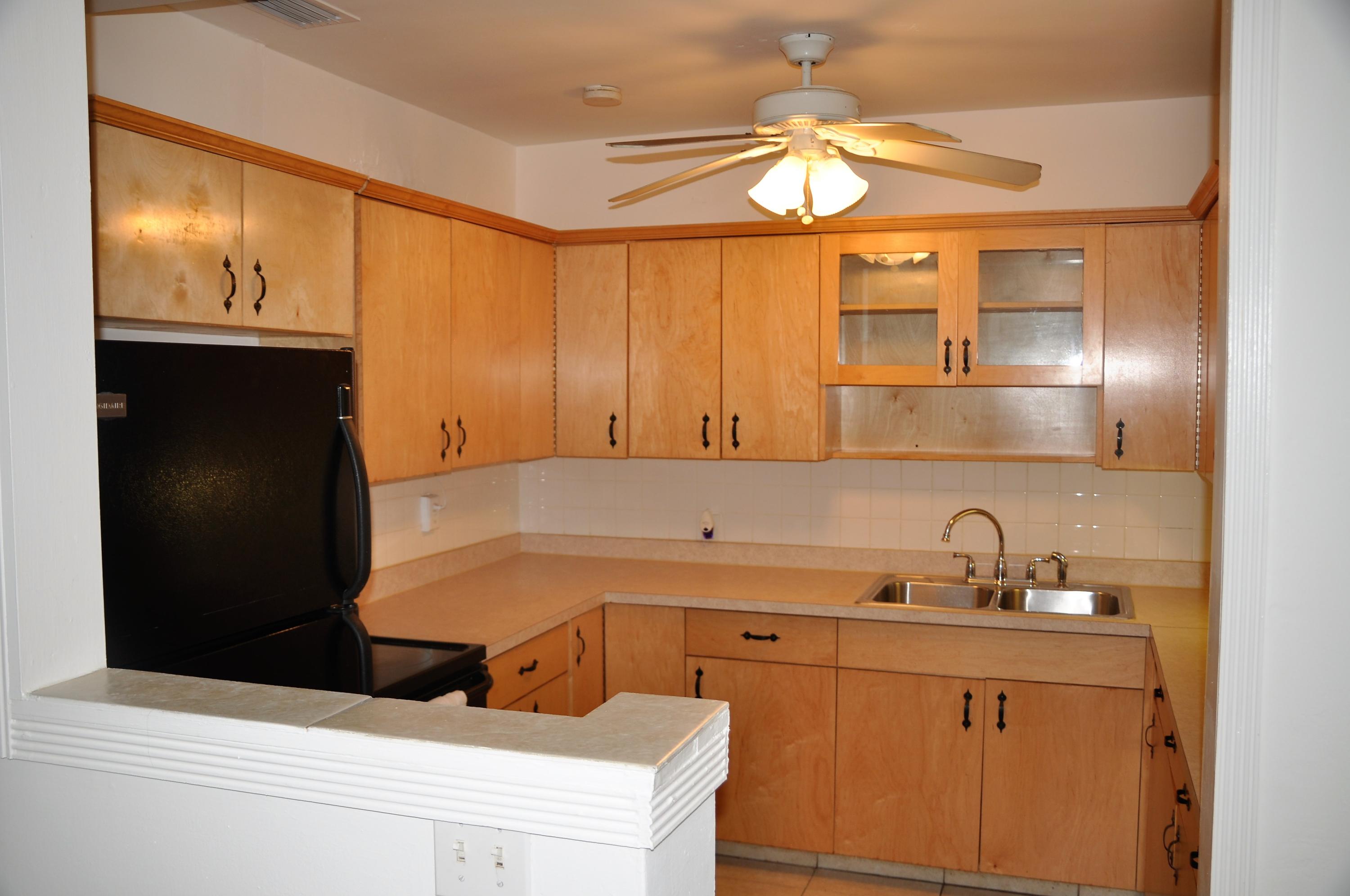 3025 Robert Road West Palm Beach, FL 33405 - Photo 4 of 41 a kitchen with a sink and cabinets