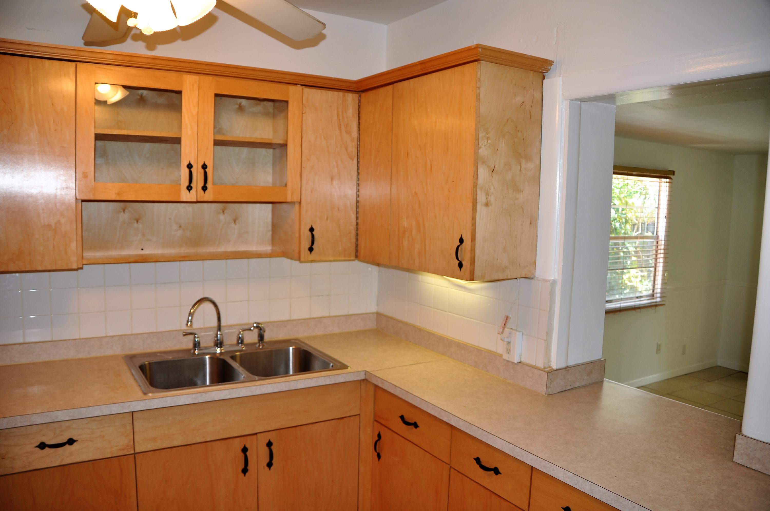 3025 Robert Road West Palm Beach, FL 33405 - Photo 7 of 41 a kitchen with a sink and a mirror