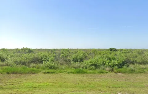 a view of a field with an ocean
