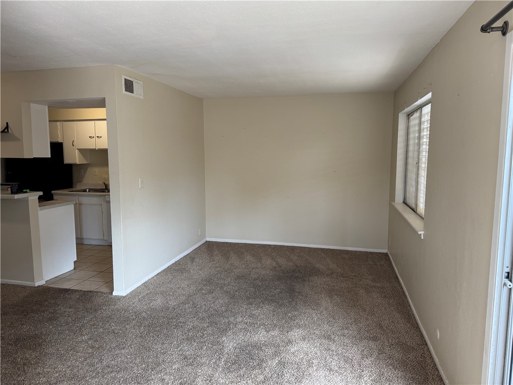 1915 Hidden Way Corpus Christi, TX 78412 - Photo 2 of 11 wooden floor in an empty room with a window