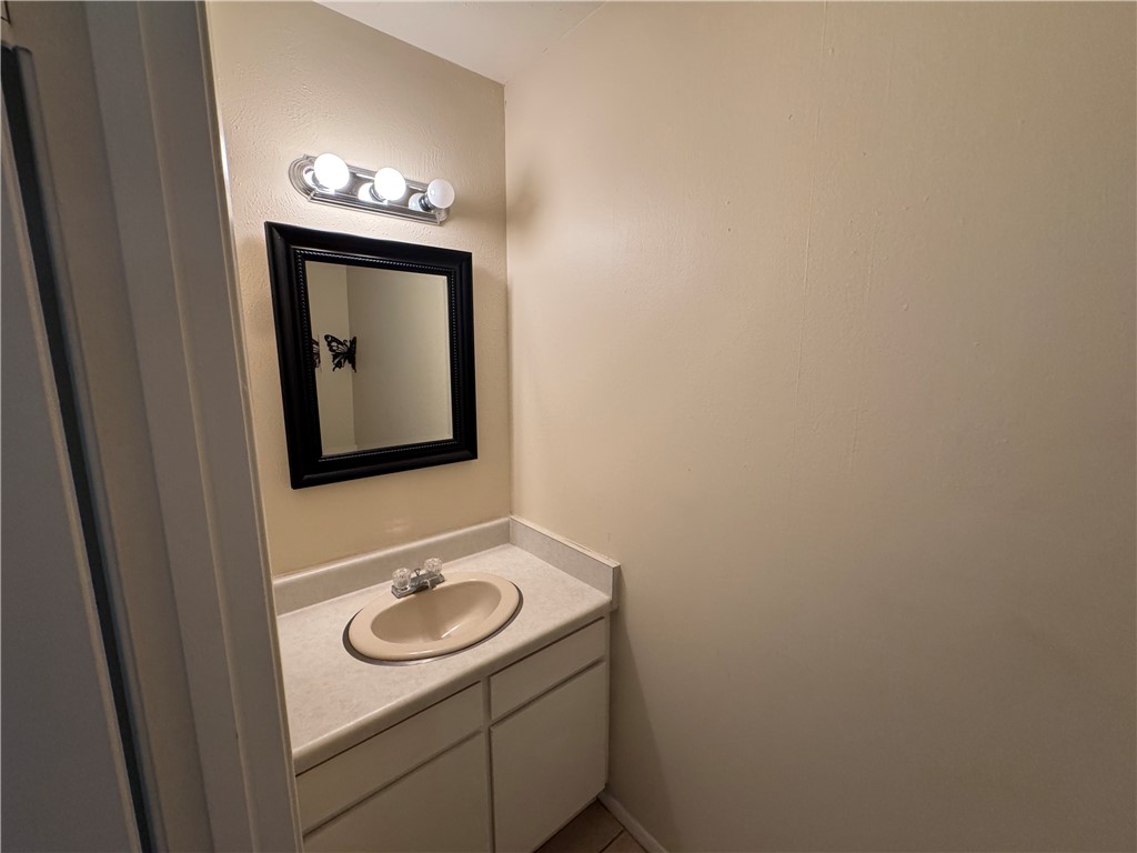 1915 Hidden Way Corpus Christi, TX 78412 - Photo 5 of 11 a bathroom with a toilet a sink and mirror