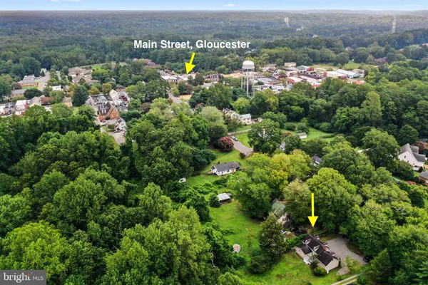 an aerial view of a houses with a lush green hillside