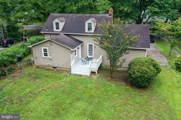 a view of a house with a yard patio and a fire pit