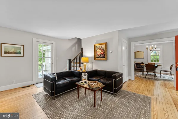 a small room with a chair and a potted plant