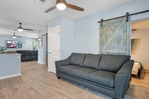a living room with furniture and a chandelier