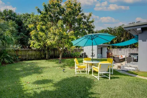a view of a patio with couches chairs and a umbrella