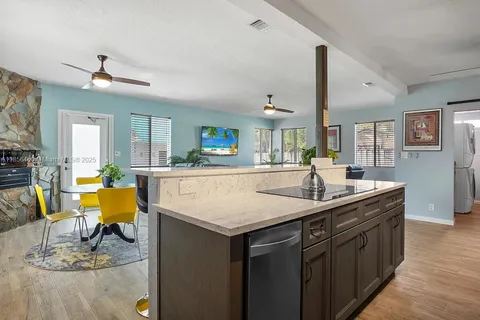 a kitchen with a table chairs and wooden floor