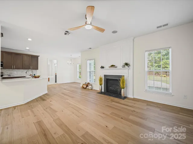 a view of an empty room with a fireplace and a window