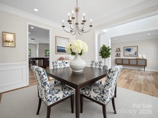 a view of a dining room with furniture and chandelier