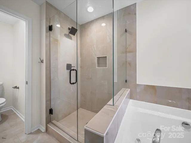 a bathroom with a bathtub and a shower