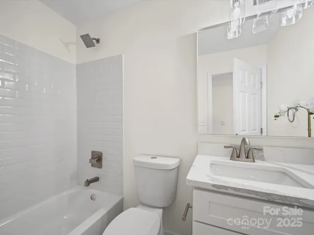 a bathroom with a sink a toilet and bathtub