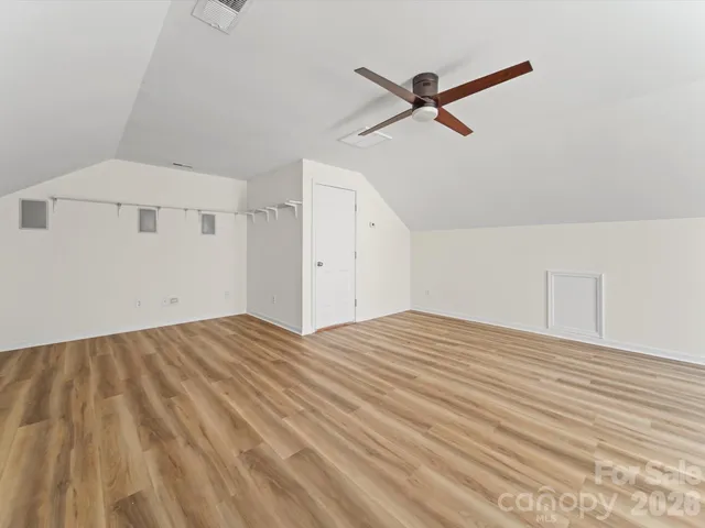 an aerial view of a house with a garden and lake view