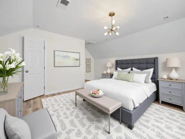 a bedroom with a bed and a chandelier