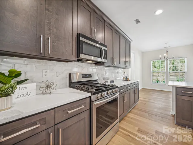 a kitchen with stainless steel appliances wooden cabinets and a sink
