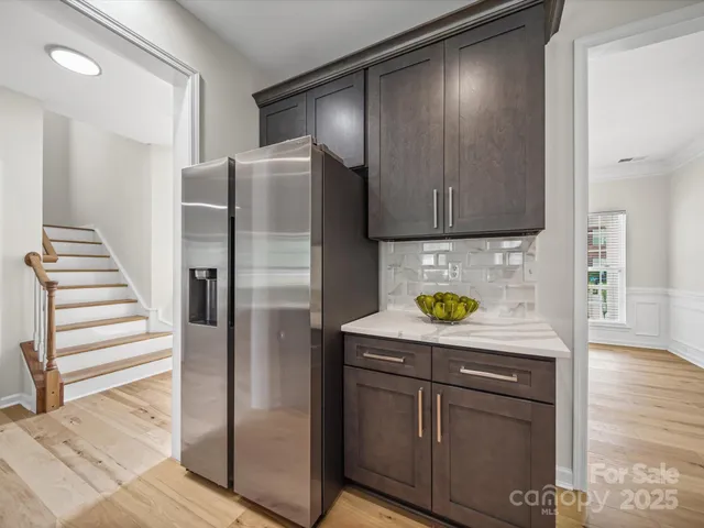 a kitchen with stainless steel appliances granite countertop a refrigerator and a stove