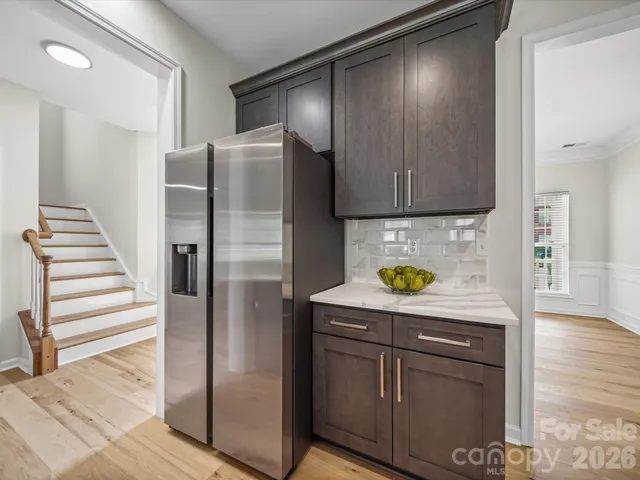a kitchen with stainless steel appliances granite countertop a refrigerator and a stove