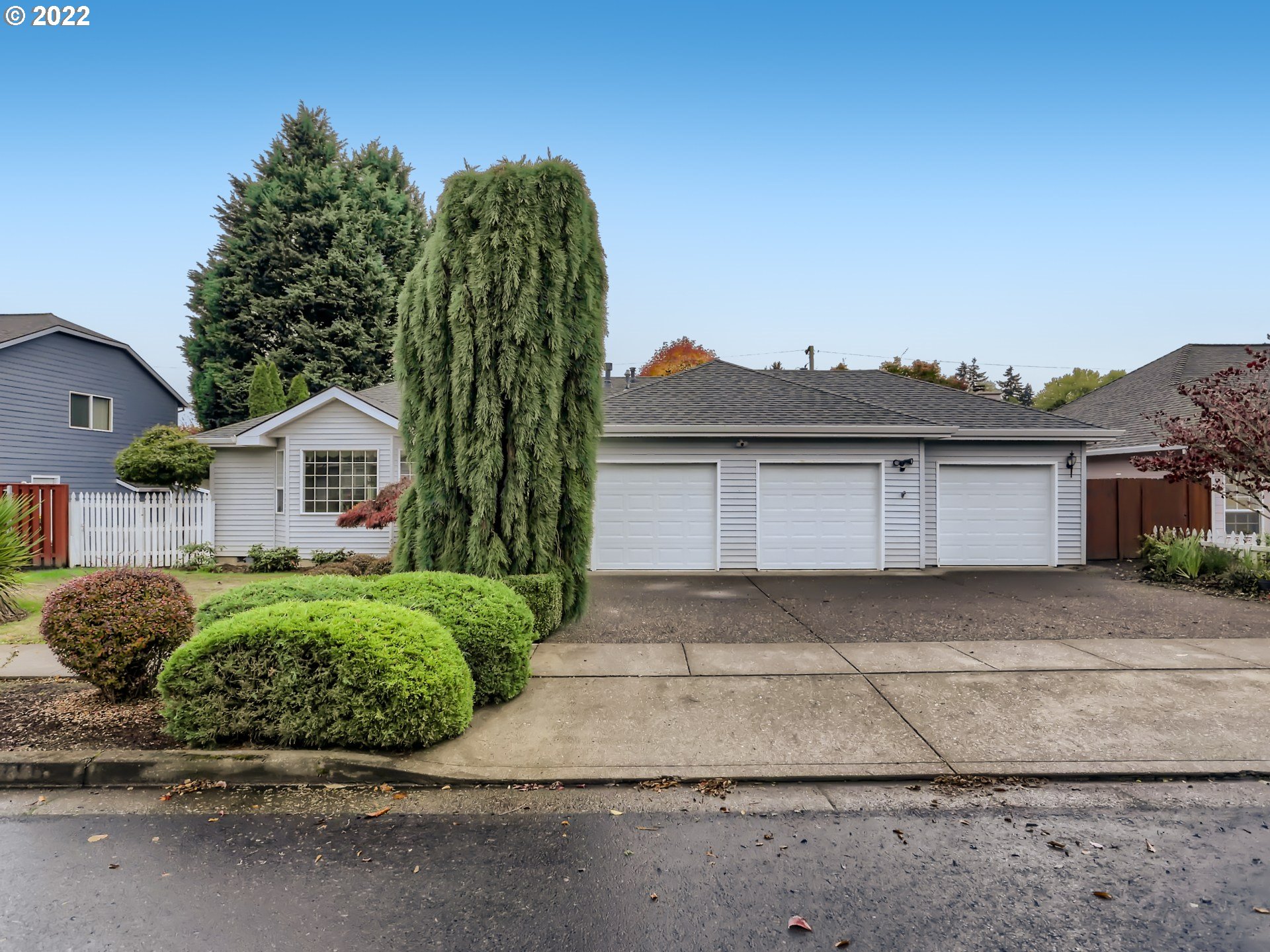 a front view of a house with a garden