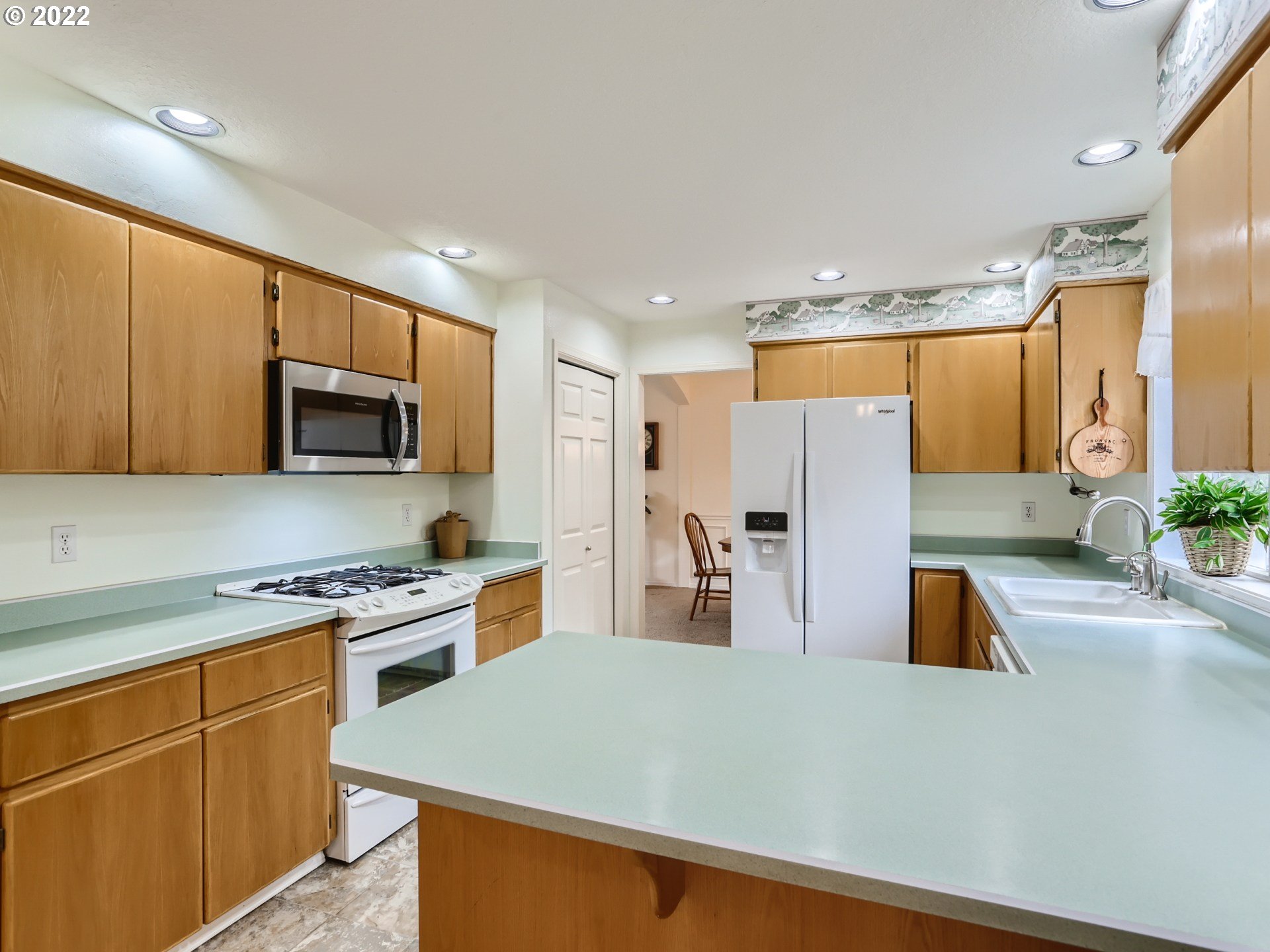 11370 Southwest Clifford Street Beaverton, OR 97008 - Photo 13 of 29 a kitchen with stainless steel appliances granite countertop a refrigerator stove microwave and sink
