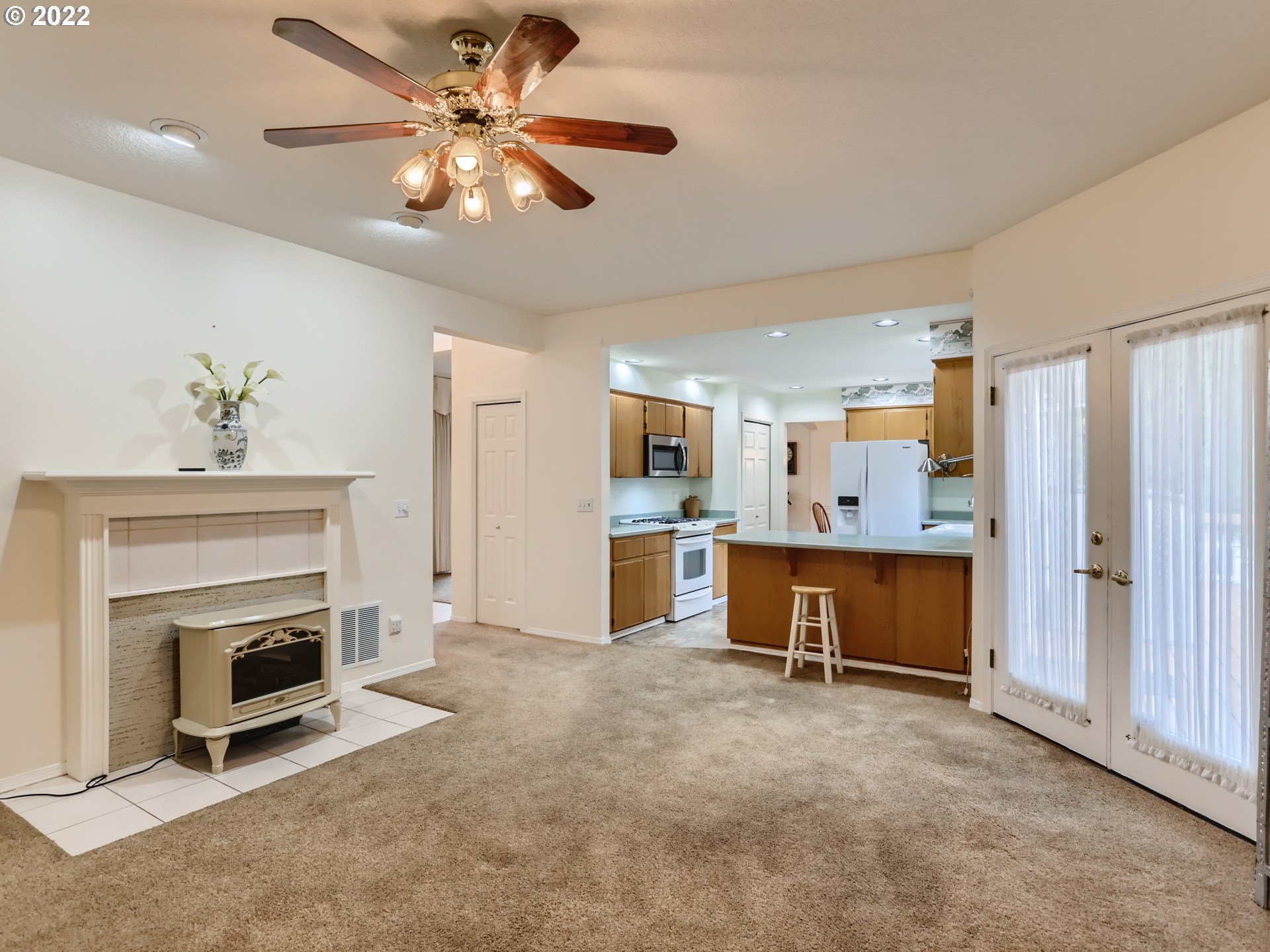 11370 Southwest Clifford Street Beaverton, OR 97008 - Photo 14 of 29 a view of a livingroom with a fireplace and a ceiling fan