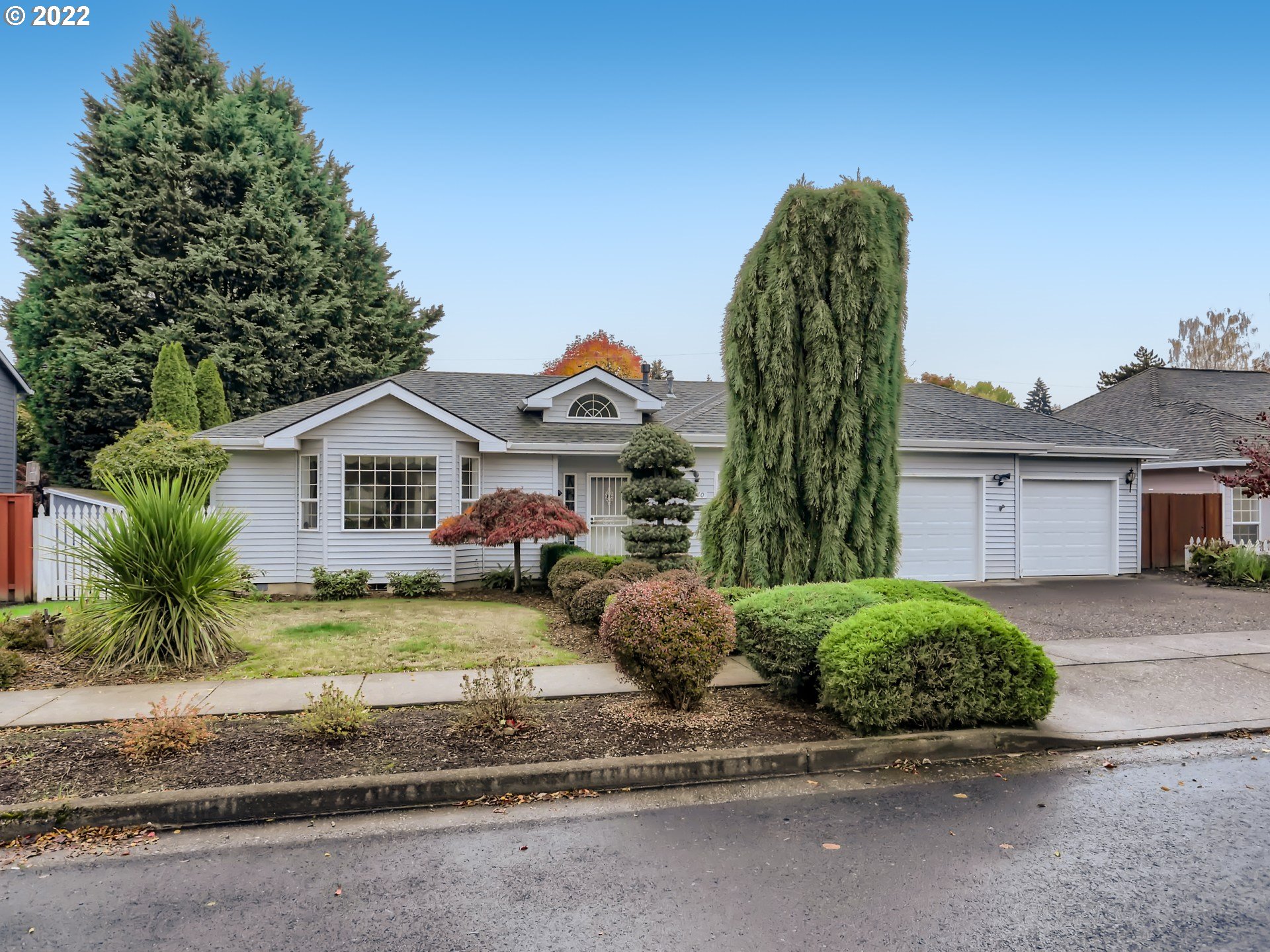 11370 Southwest Clifford Street Beaverton, OR 97008 - Photo 2 of 29 a front view of a house with a yard and garage
