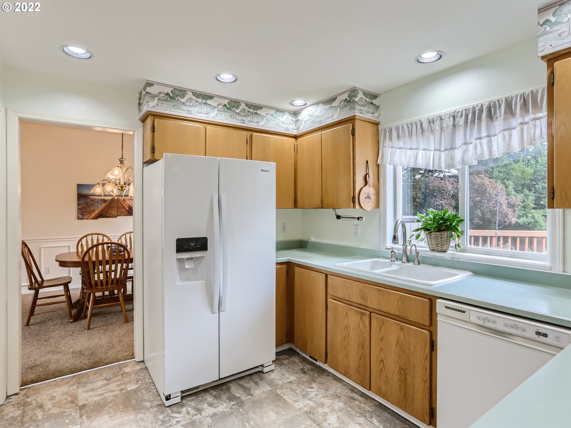 11370 Southwest Clifford Street Beaverton, OR 97008 - Photo 9 of 29 a kitchen with a refrigerator a sink and chairs