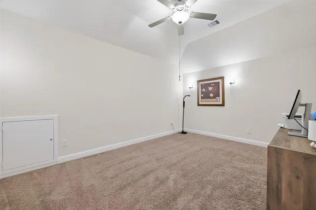 a view of a room with furniture and a chandelier fan