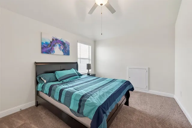 a bedroom with a bed and pillows