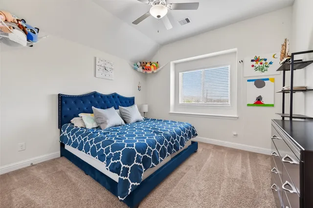 a bedroom with a bed and a television