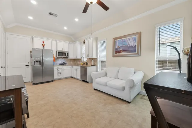 a kitchen with stainless steel appliances granite countertop a refrigerator sink and cabinets
