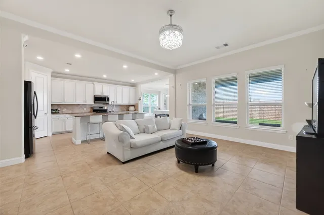 a living room with furniture and a chandelier