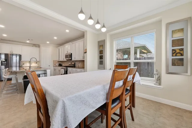 a kitchen with stainless steel appliances granite countertop a stove top oven a sink a refrigerator with white cabinets and granite countertops