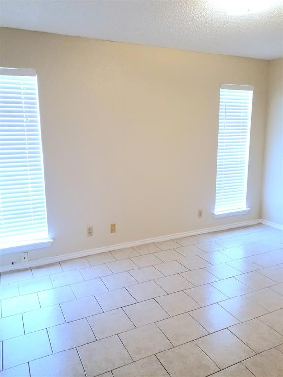 407 Gatewood Road, Unit 407 Garland, TX 75043 - Photo 3 of 6 Primary bedroom with windows to brighten your space.