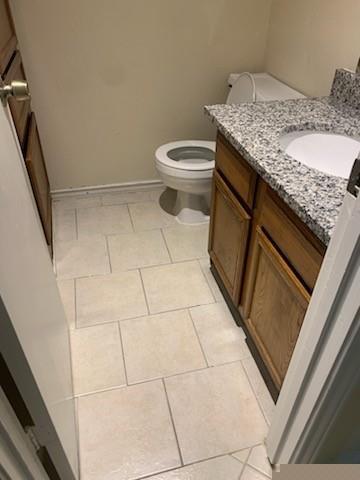 407 Gatewood Road, Unit 407 Garland, TX 75043 - Photo 5 of 6 Half bath with granite countertops and builtin linen cabinet.