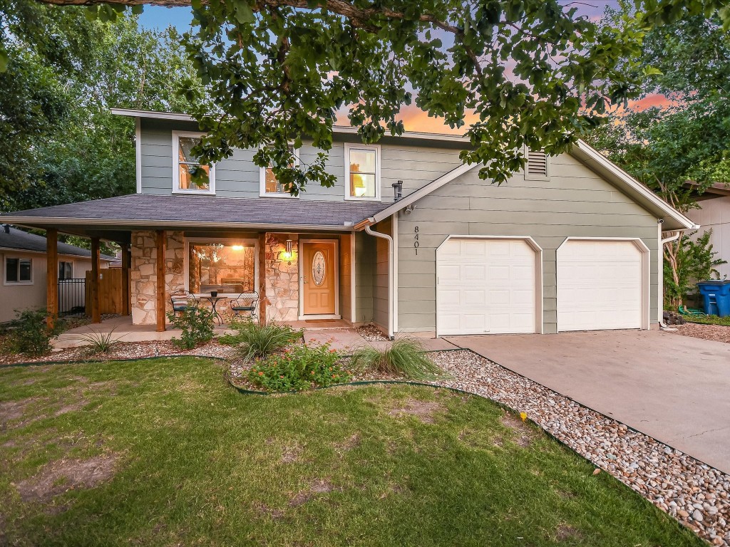 a front view of a house with a yard and porch