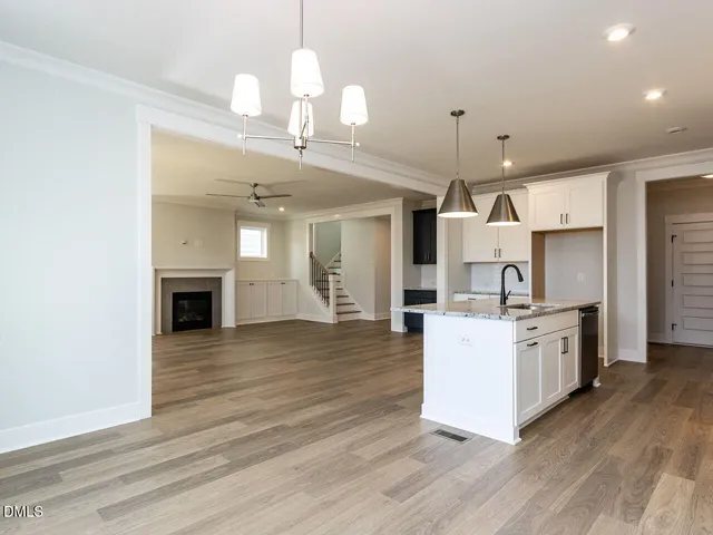 a large kitchen with cabinets wooden floor and stainless steel appliances
