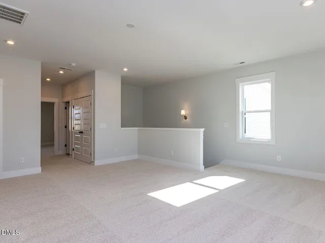 an empty room with windows and entrance