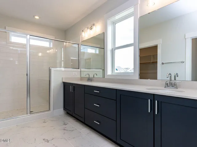 a bathroom with a double vanity sink mirror and double