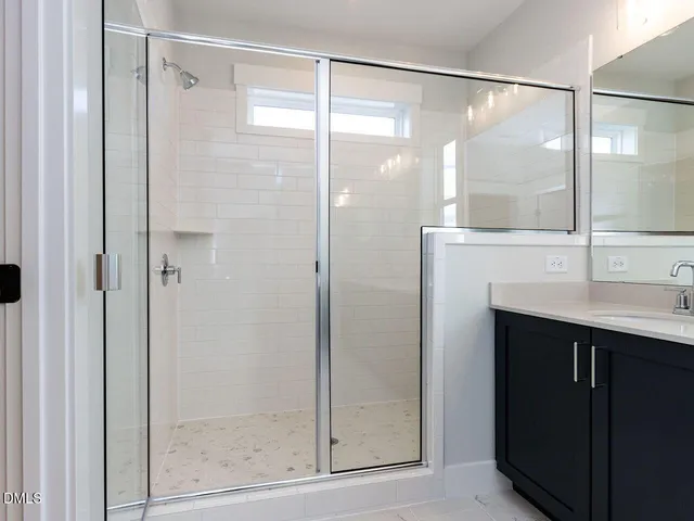 a bathroom with a shower and a sink