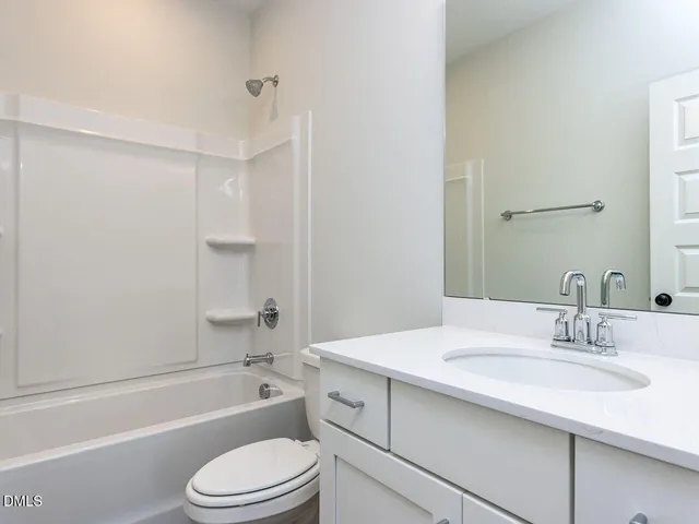 a bathroom with a bathtub and a toilet