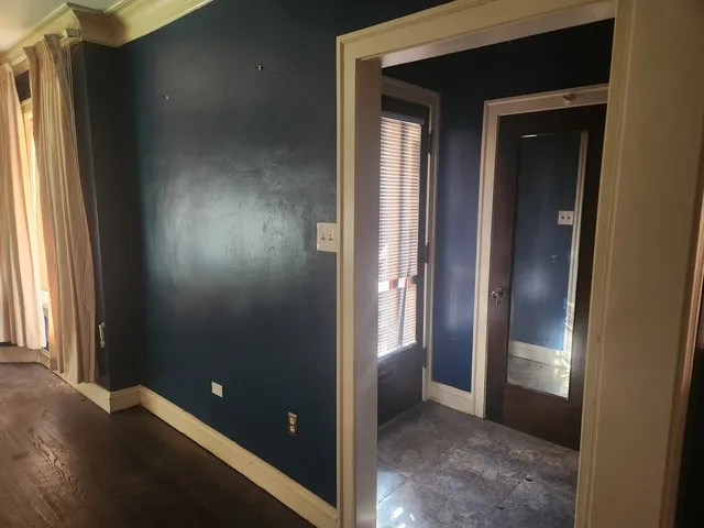 an empty room with windows and closet