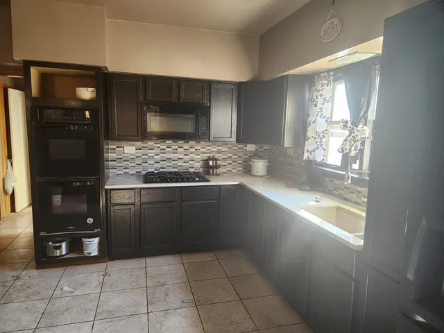 a kitchen with a sink and a refrigerator